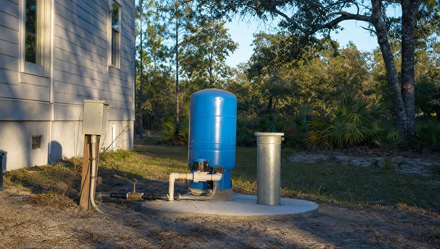 A private wellhead and pressure tank beside a rural home outside Jacksonville